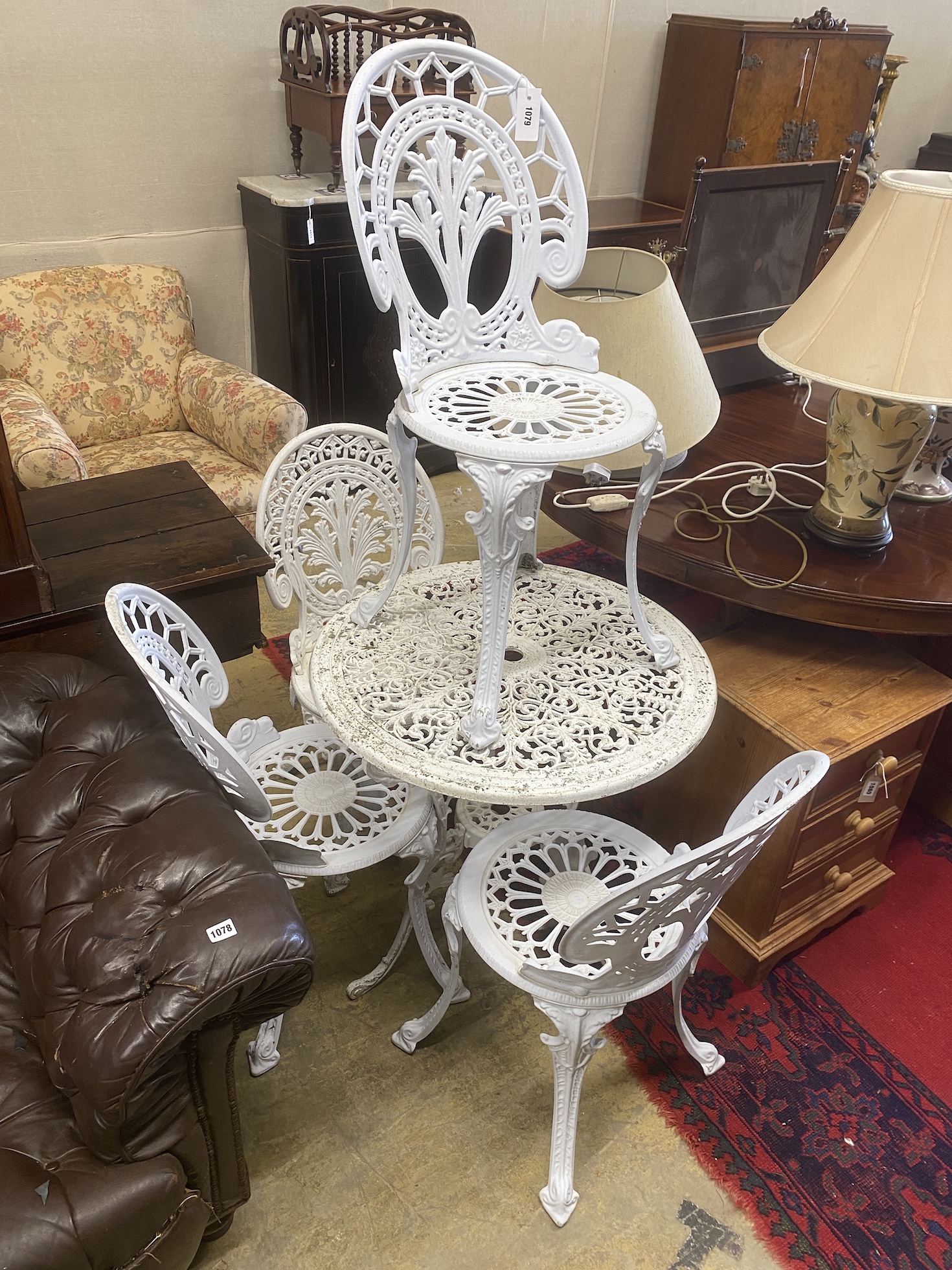 A Victorian style aluminium circular painted aluminium garden table, diameter 68cm, height 69cm together with four chairs (3 + 1)